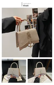 Detail of khaki sequin shoulder bag with sparkling texture and gold tassel charm