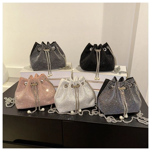 Macro view of drawstring rhinestone bucket bags with crystal texture and pearl details