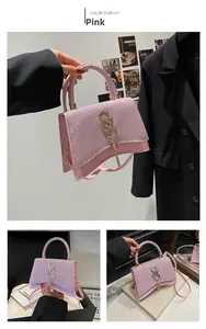 Close-up of pink sequined handbag with gold S-buckle and long tassel details