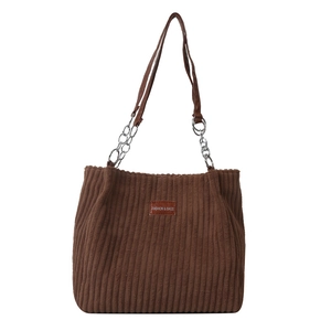 Brown corduroy tote bag with leather handles and chain detail for casual fashion