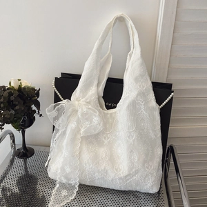 Elegant white lace tote bag with floral embroidery and large decorative bow detail