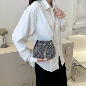 Elegant rhinestone drawstring bucket bag with pearl accents and silver chain strap