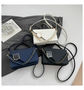 Detailed view of woven chain straps and metallic square buckles on stylish PU leather bags