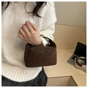 Close-up of leopard print handbag with premium gold twist-lock closure detail