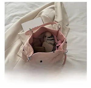 Pink quilted tote bag with spacious interior for phone, wallet and daily essentials
