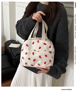 Detail of corduroy tote bag with strawberry print showing soft fabric texture and straps
