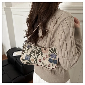 Floral brocade baguette bag with dragonfly embroidery shown on model for size and style