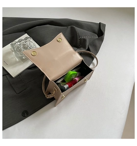 Interior view of beige leather mini shoulder bag showing space for phone and makeup