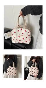 Detail of corduroy tote bag with red strawberry print and sturdy webbing handles
