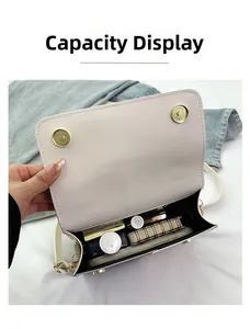 Interior view of ivory shoulder bag showing large capacity for cosmetics and notebooks