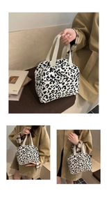 Detail of leopard print corduroy tote showing zip closure and side pocket functionality