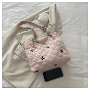 Pink quilted tote bag with black rabbit embroidery and silver chain strap detail