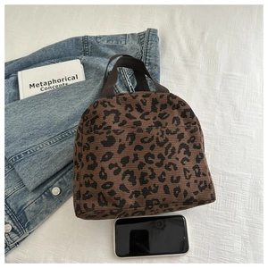 Detail of leopard print lunch bag in textured corduroy with durable canvas handles