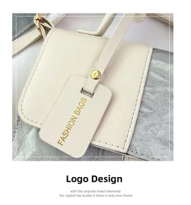 Detail of cream PU leather crossbody bag with silver texture and branded fashion tag