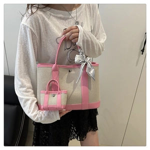 Pink and beige canvas tote with leather trim, mini bag charm and floral scarf detail