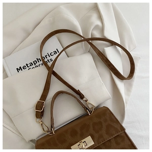 Detail der Vintage-Handtasche mit Leopardenmuster, goldenem Drehverschluss und Schnalle