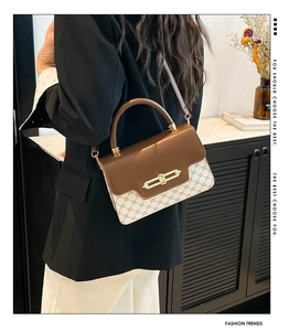 Detailed view of vintage patchwork shoulder bag with leather flaps and metallic lock