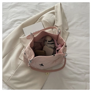 Top view of open pink quilted tote bag showing large capacity for daily essentials