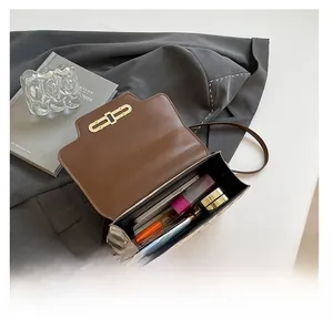 Internal view showing capacity of this retro monogram crossbody bag with personal items