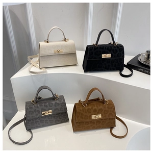 Chic leopard print handbags in four colors with gold twist locks and shoulder straps