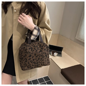 Detail of trendy corduroy tote bag with leopard print and durable nylon handles
