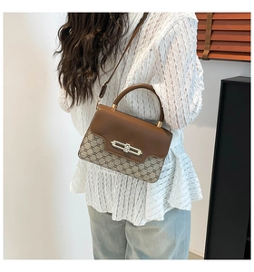 Classic brown patchwork leather crossbody bag with vintage lock shown on model