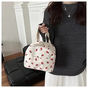 Detail of cute strawberry print on corduroy lunch bag with sturdy top handles