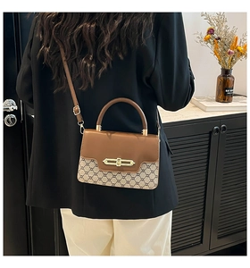Detail of vintage patchwork crossbody bag featuring classic brown monogram and gold lock