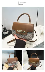 Macro detail of the brown monogram canvas texture and golden oval clasp on a crossbody bag