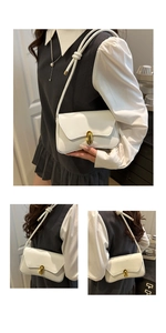 Detailed view of white PU leather handbag with elegant gold U-shaped metal buckle lock