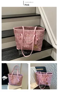 Vue détaillée du sac cabas rose avec texture mosaïque et pendentif doré en forme de M