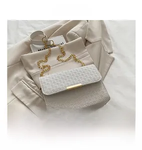 Detailed size comparison of white woven chain bag next to a smartphone on a beige blazer