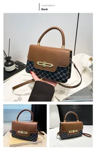 Detail of color-block shoulder bag featuring vintage pattern and golden metal buckle clasp