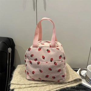 Pink corduroy lunch bag with cute strawberry pattern and sturdy fabric handles