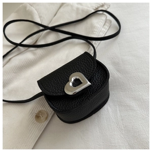 Detail of silver heart buckle on black lychee grain leather mini square crossbody bag