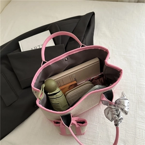 Canvas tote bag with pink leather trim and scarf, showing spacious interior for daily items