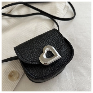 Close-up of black litchi grain leather mini bag with silver heart-shaped metal buckle