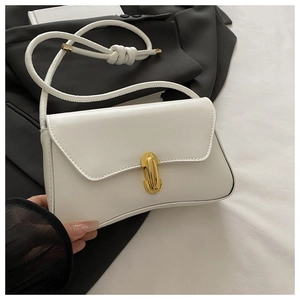 Close-up of a white leather shoulder bag featuring a gold U-shaped metal buckle detail