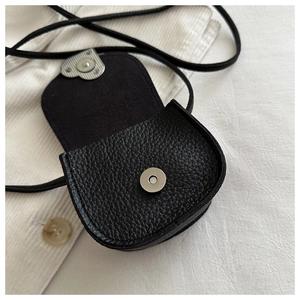 Close-up of black pebble leather mini square bag showing silver magnetic closure
