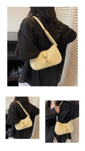 Multiple views of a pale yellow crescent shoulder bag with metallic buckle detail