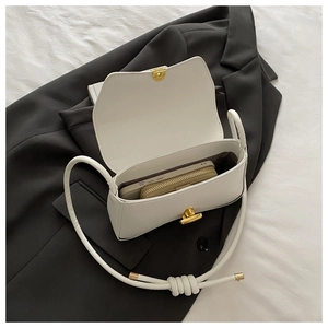 Detailed view of white PU leather shoulder bag showing gold clasp and internal capacity