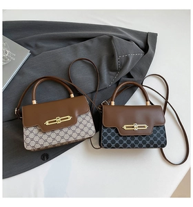 Detail view of large canvas flap bags with gold vintage buckles and leather straps