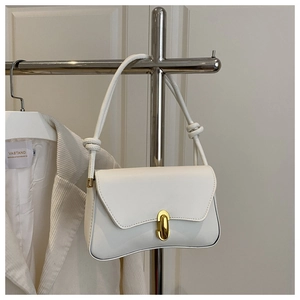 Detail of white minimalist crossbody bag with gold buckle and stylish knotted shoulder strap