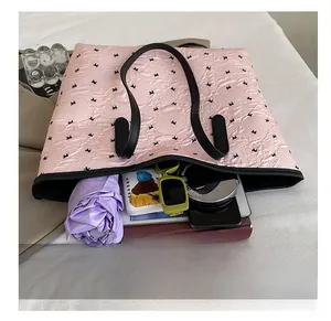 Spacious pink tote bag interior showing capacity for umbrella, sunglasses and essentials