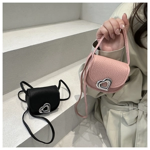 Detail of elegant heart-shaped silver buckles on lychee grain leather mini flap bags