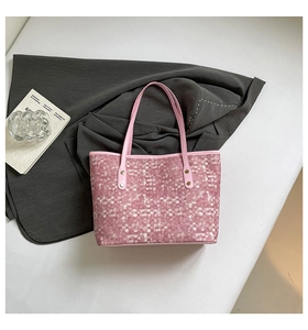 Top view of pink checkered tote bag featuring leather handles and gold rivet details