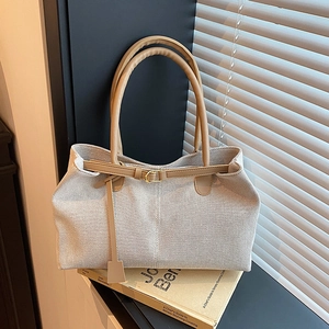 Minimalist beige canvas tote bag with brown faux leather trim and golden buckles