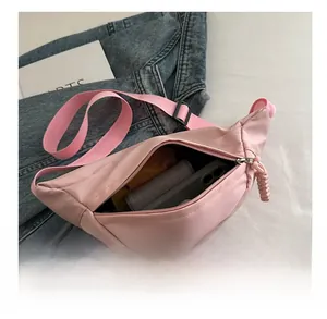Detail view of pink nylon dumplings bag showing spacious interior for phone and wallet