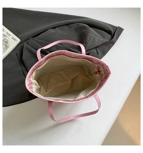 Top view of pink tote bag showing spacious interior with creamy fabric lining and metal zipper