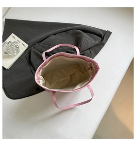 Top-down view of a spacious pink tote bag interior showing the beige fabric lining